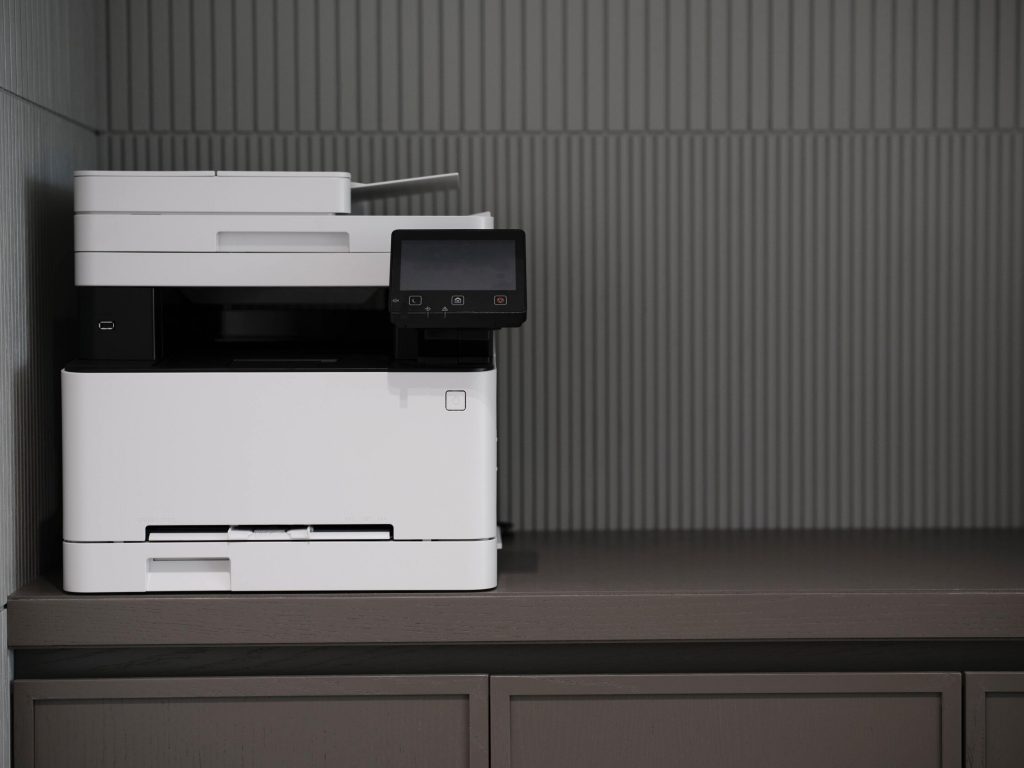 Black and white printer on a black counter 