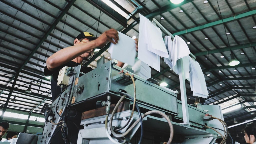 A man operating a print machine